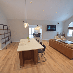 Modern kitchen island with bar seating overlooking open living space in a stylish vacation rental home.