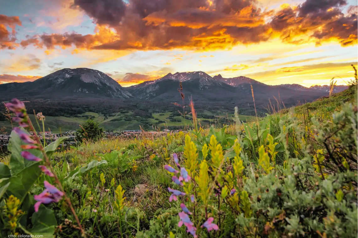 Things to do in Silverthorne CO — aerial view of Silverthorne in summer with mountain trails and the Rocky Mountains visible in the background.