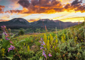 Things to do in Silverthorne CO — aerial view of Silverthorne in summer with mountain trails and the Rocky Mountains visible in the background.